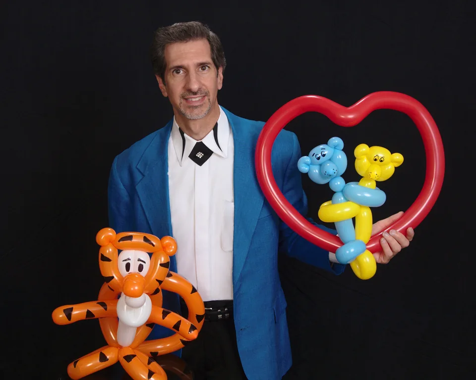 Tony with his tiger and heart-shaped balloon creations